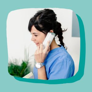 a nurse in scrubs is making a telephone call
